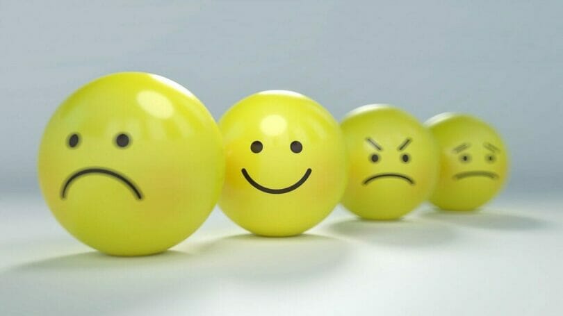 Four yellow emoji face balls displaying different emotions: sad, happy, angry, and disappointed, arranged in a row.