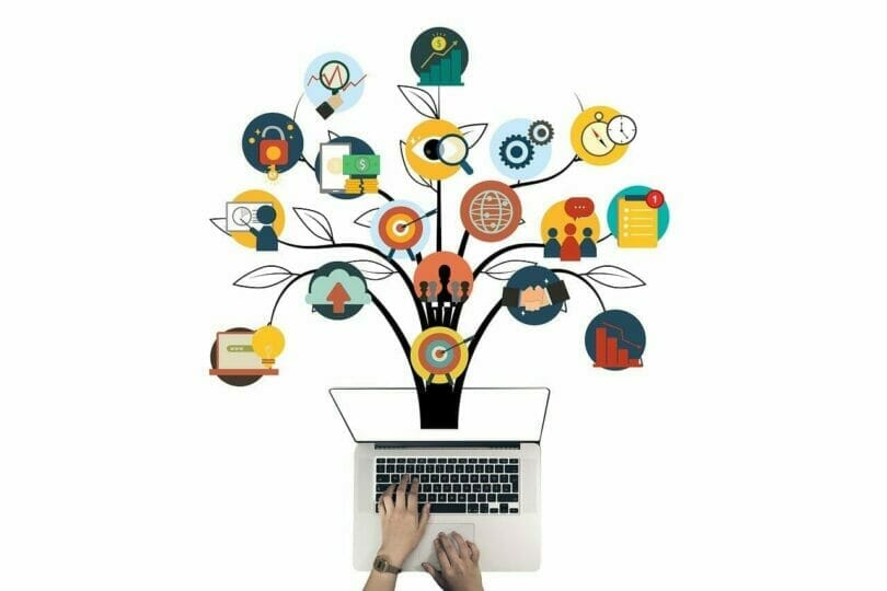 Hands typing on a laptop; a tree of interconnected icons above represents various concepts like finance, teamwork, and technology.