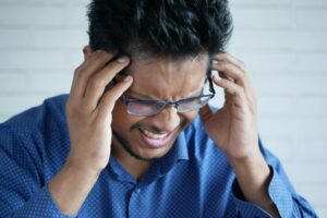 a visibly stressed indian man
